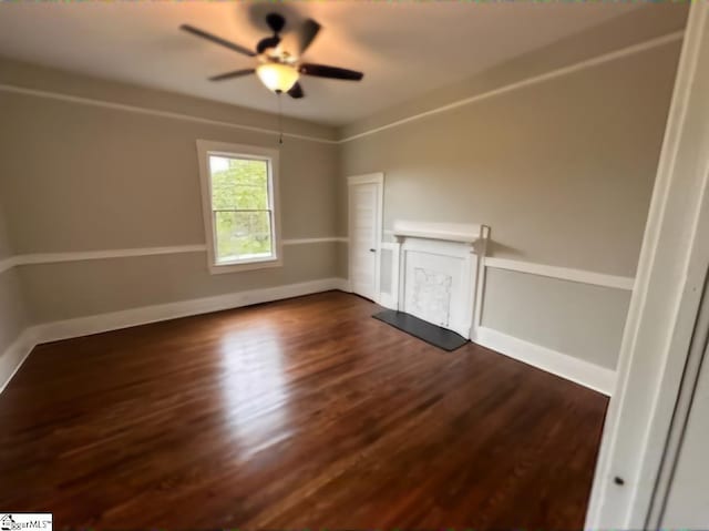 empty room featuring ceiling fan and dark hardwood / wood-style floors