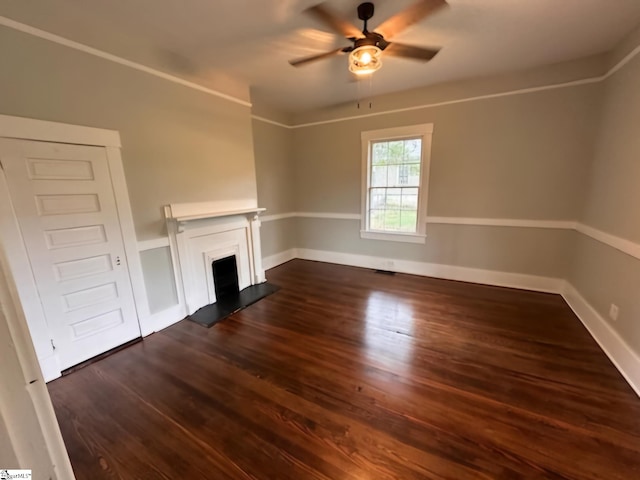 unfurnished living room with ceiling fan and dark hardwood / wood-style flooring