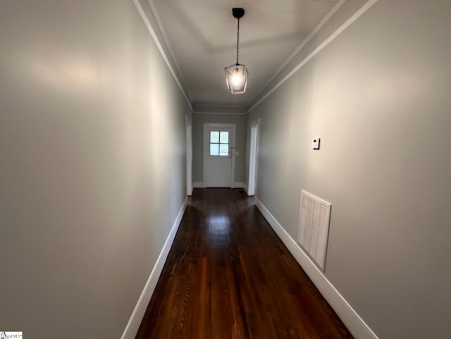 entryway featuring ornamental molding and dark wood-type flooring