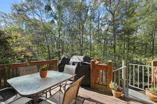 wooden terrace featuring grilling area