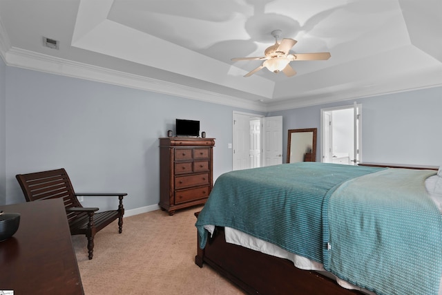 carpeted bedroom with crown molding, ceiling fan, and a raised ceiling