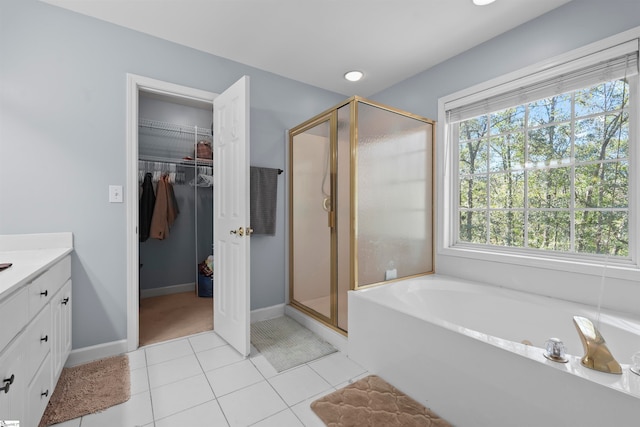 bathroom with vanity, plus walk in shower, and tile patterned flooring