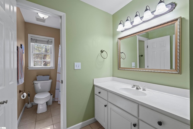 bathroom with vanity, tile patterned flooring, and toilet