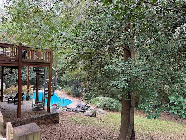 view of yard with a pool side deck