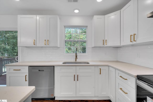 kitchen with tasteful backsplash, dark hardwood / wood-style flooring, sink, dishwasher, and white cabinets