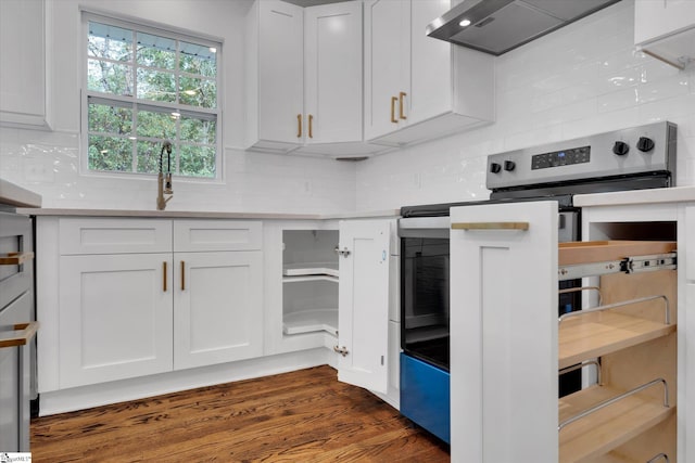 kitchen featuring dark wood-type flooring, wall chimney exhaust hood, white cabinetry, and electric stove