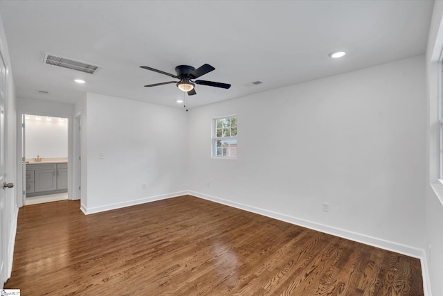 unfurnished room featuring ceiling fan and dark hardwood / wood-style floors