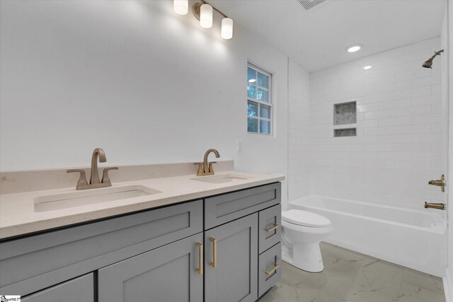 full bathroom with vanity, toilet, and tiled shower / bath combo