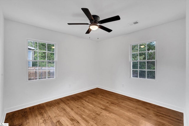 empty room with hardwood / wood-style flooring and ceiling fan