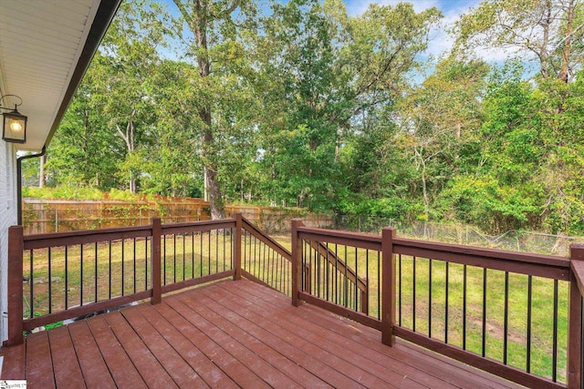 wooden terrace featuring a lawn