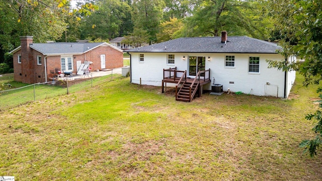 rear view of house with a patio, a yard, and central AC unit