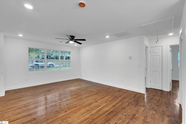 unfurnished room with ceiling fan and dark wood-type flooring