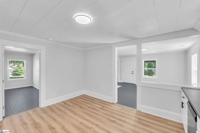 empty room featuring ornamental molding and light wood-type flooring