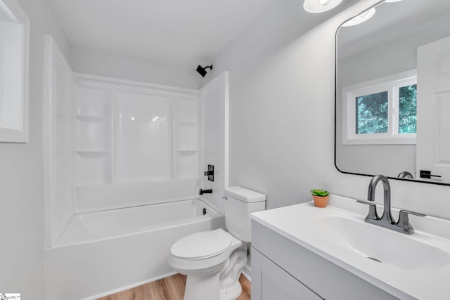 full bathroom featuring toilet, vanity, wood-type flooring, and shower / washtub combination