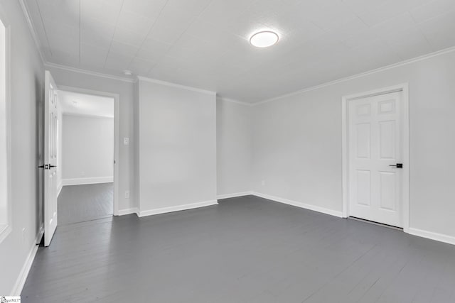 spare room with ornamental molding and dark wood-type flooring