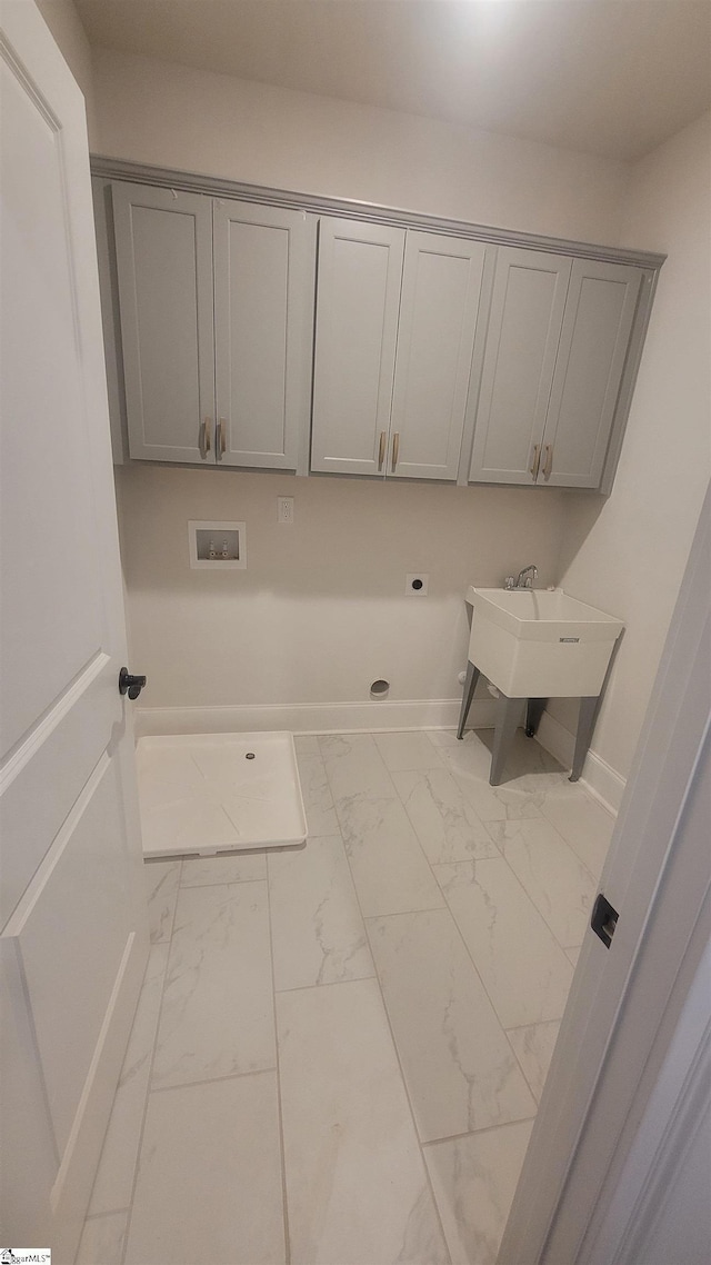 laundry room featuring cabinet space, marble finish floor, electric dryer hookup, washer hookup, and a sink