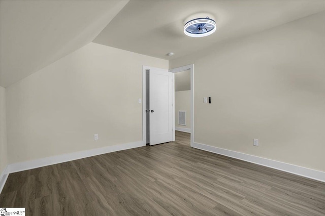 bonus room featuring dark hardwood / wood-style floors and vaulted ceiling