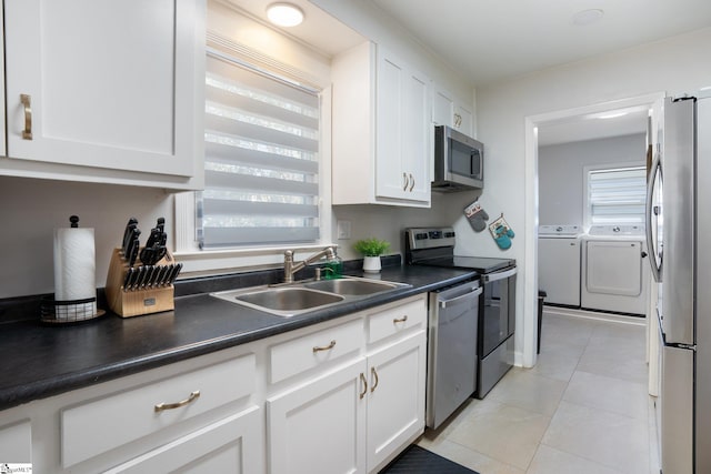 kitchen with white cabinets, sink, stainless steel appliances, and independent washer and dryer