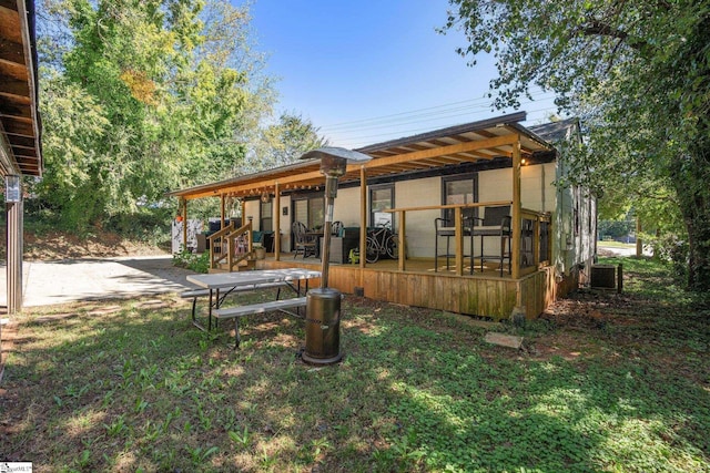 exterior space featuring a pergola, central AC, and a lawn