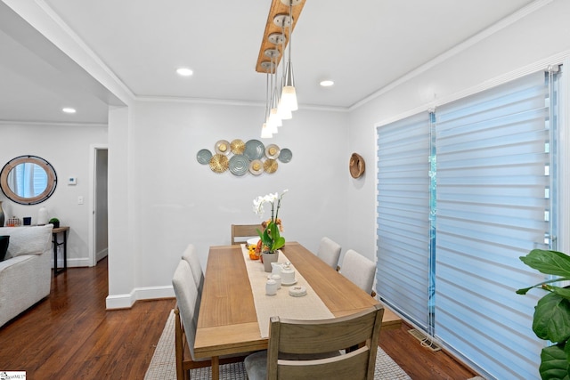 dining room with crown molding and dark hardwood / wood-style floors