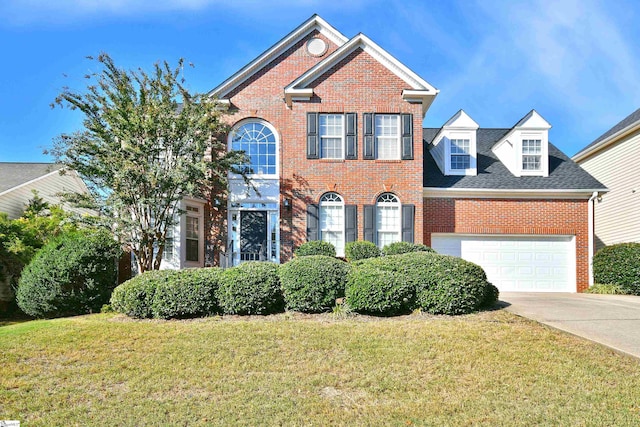 view of front of property with a front yard and a garage