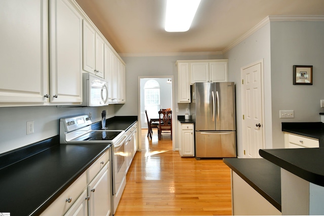 kitchen with stainless steel refrigerator, white cabinets, light hardwood / wood-style flooring, and range with electric stovetop