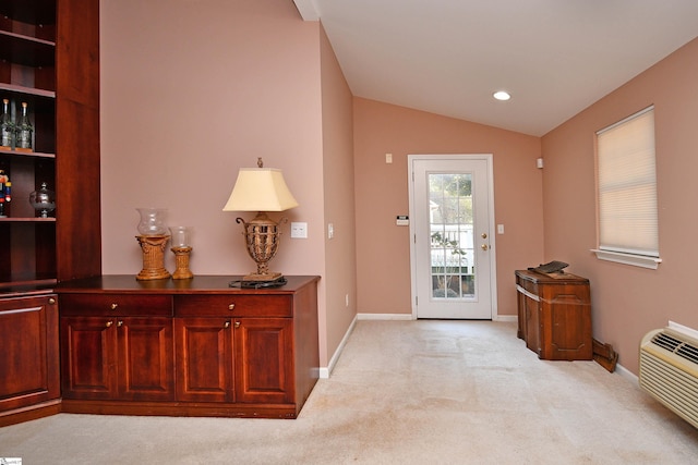 doorway to outside featuring light colored carpet and vaulted ceiling