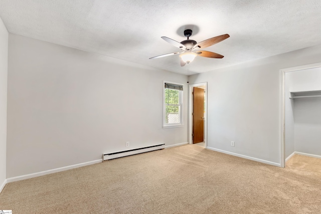 unfurnished bedroom featuring ceiling fan, light colored carpet, a textured ceiling, and baseboard heating