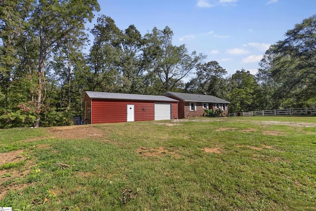 view of yard with a garage and an outdoor structure