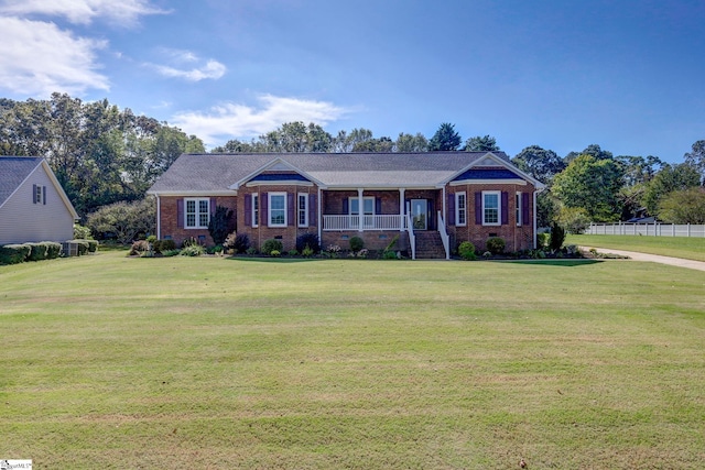 ranch-style house with a porch and a front yard