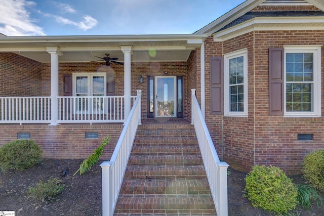 entrance to property featuring covered porch and ceiling fan