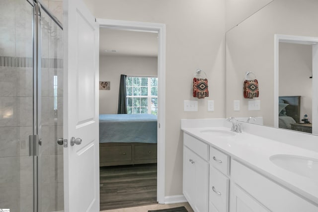 bathroom featuring an enclosed shower, wood-type flooring, and vanity