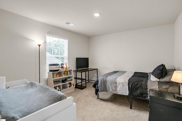 bedroom with light colored carpet