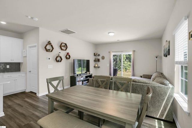 dining area with dark hardwood / wood-style flooring