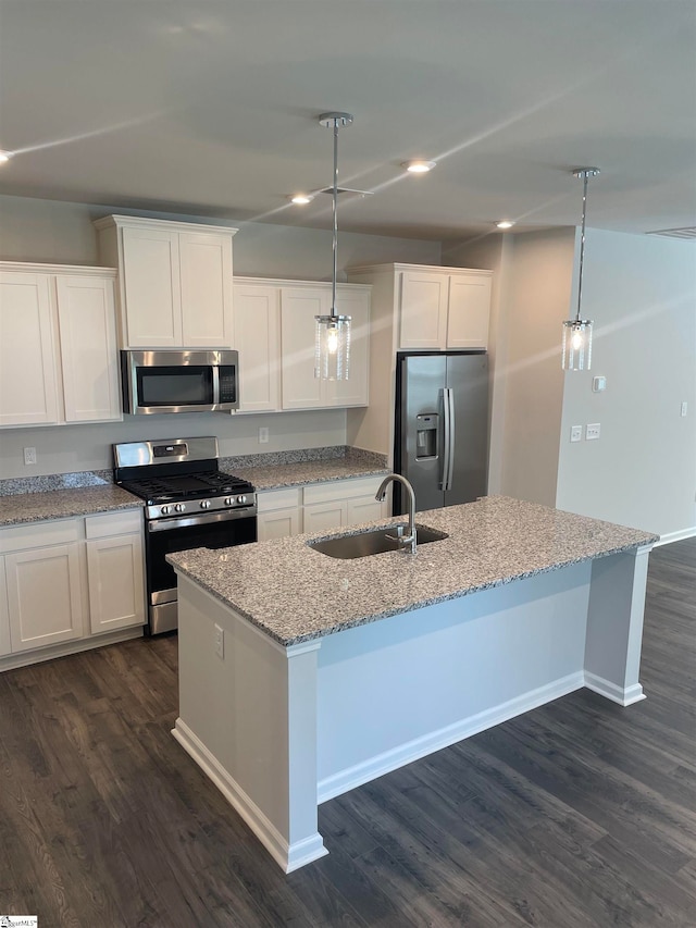 kitchen with pendant lighting, sink, dark hardwood / wood-style floors, and stainless steel appliances