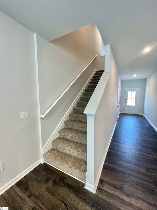 staircase with wood-type flooring