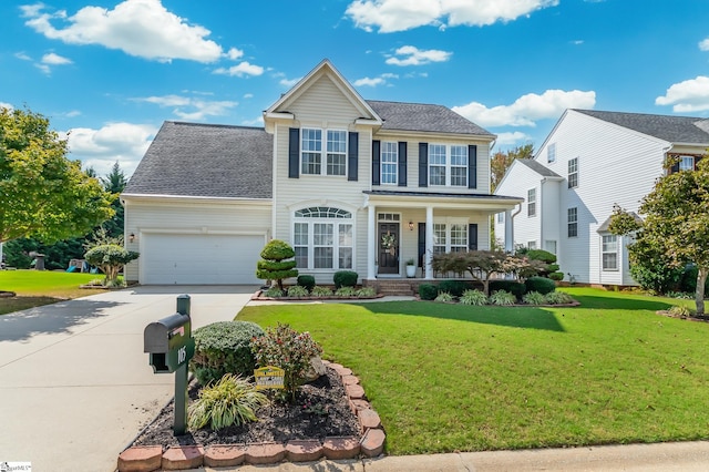 colonial home with a garage, a porch, and a front yard