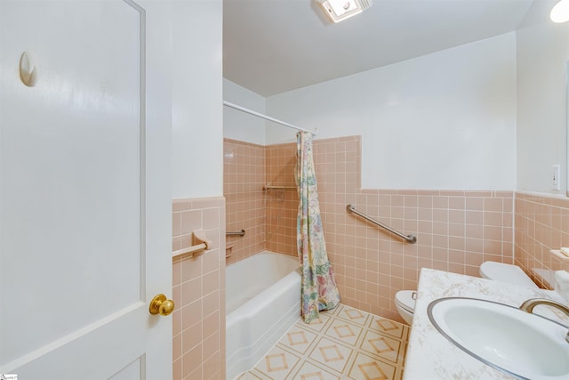 full bathroom with vanity, shower / tub combo with curtain, toilet, and tile walls