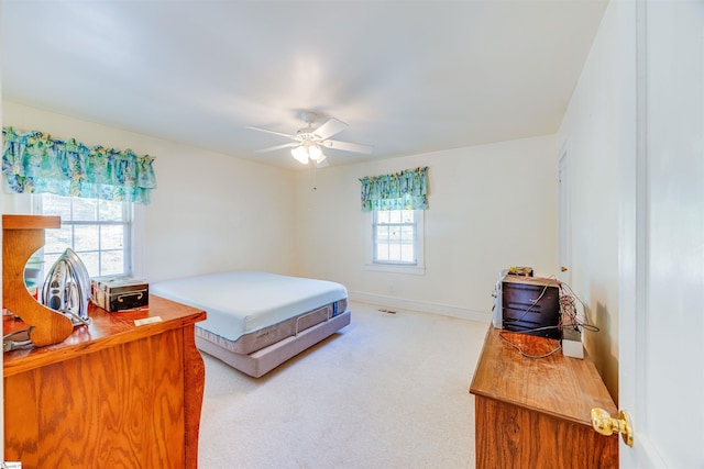 bedroom featuring light colored carpet and ceiling fan