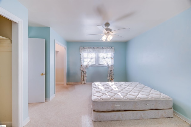 bedroom with ceiling fan and light carpet