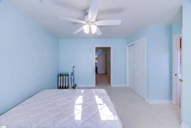 bedroom with light carpet, a closet, and ceiling fan