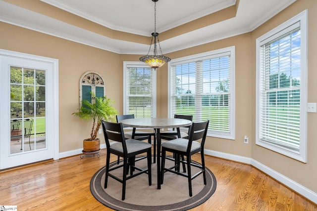 dining area featuring crown molding, plenty of natural light, and light hardwood / wood-style flooring