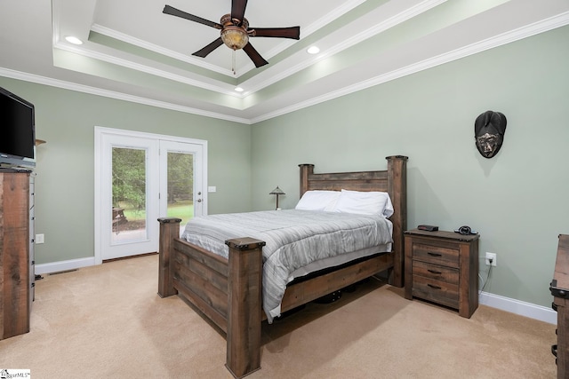 carpeted bedroom with ceiling fan, a raised ceiling, crown molding, and access to exterior