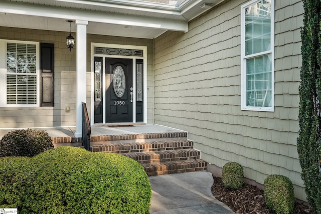 view of exterior entry with covered porch