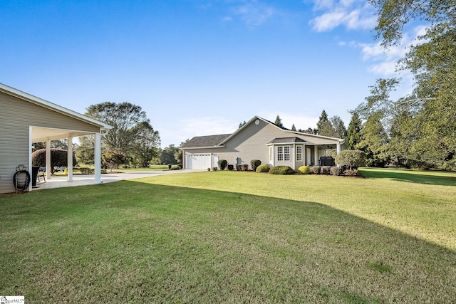 view of yard with a garage and a carport