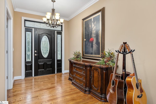 entryway with light hardwood / wood-style flooring, a chandelier, and ornamental molding