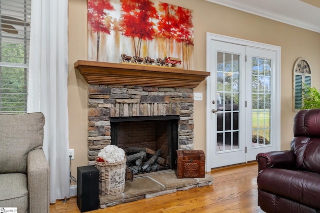 interior space with crown molding, a stone fireplace, and light hardwood / wood-style flooring