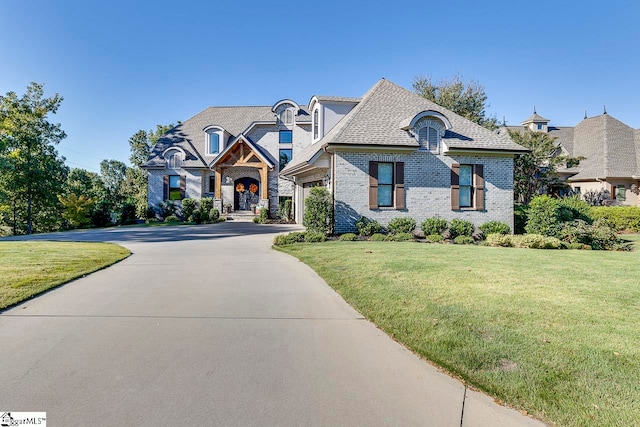 french country style house with a front yard