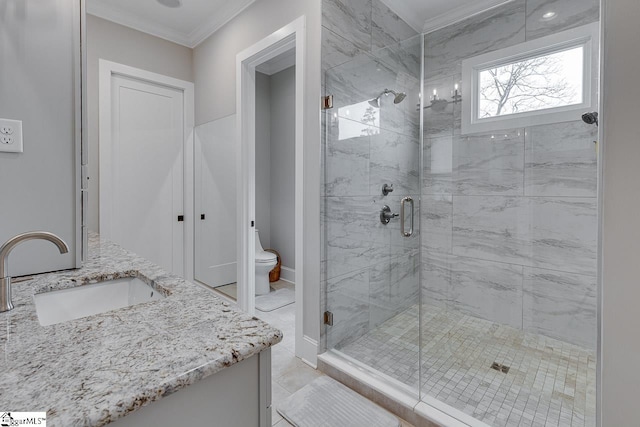 bathroom featuring crown molding, vanity, a shower with door, and toilet