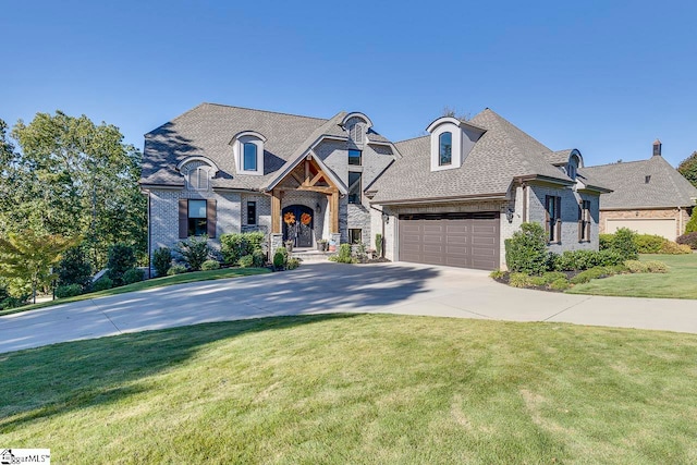 french country style house with a garage and a front lawn